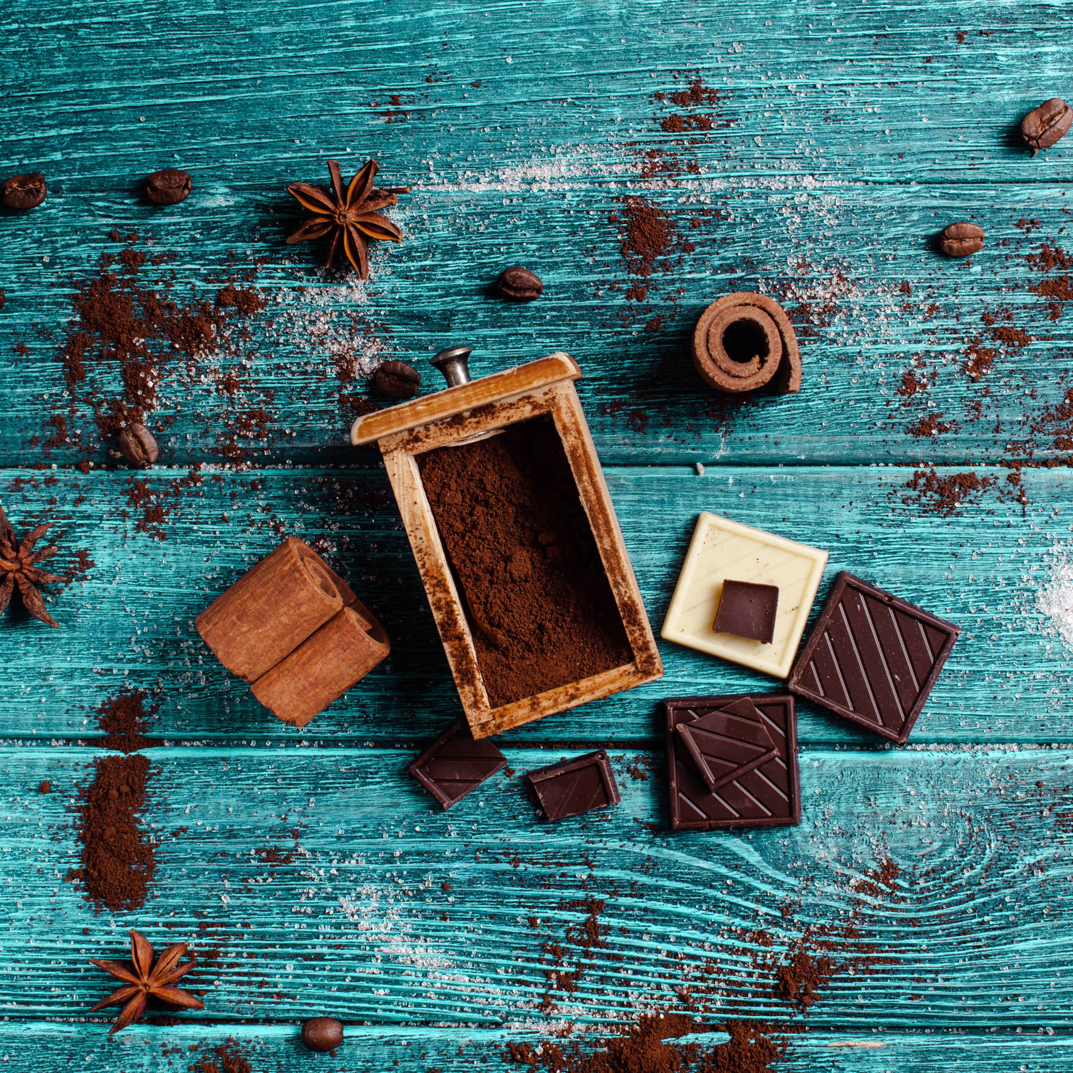 Overhead view of coffee grounds, cocoa powder, and spices highlights polyphenols, promoting antioxidant-rich choices for health and wellness.